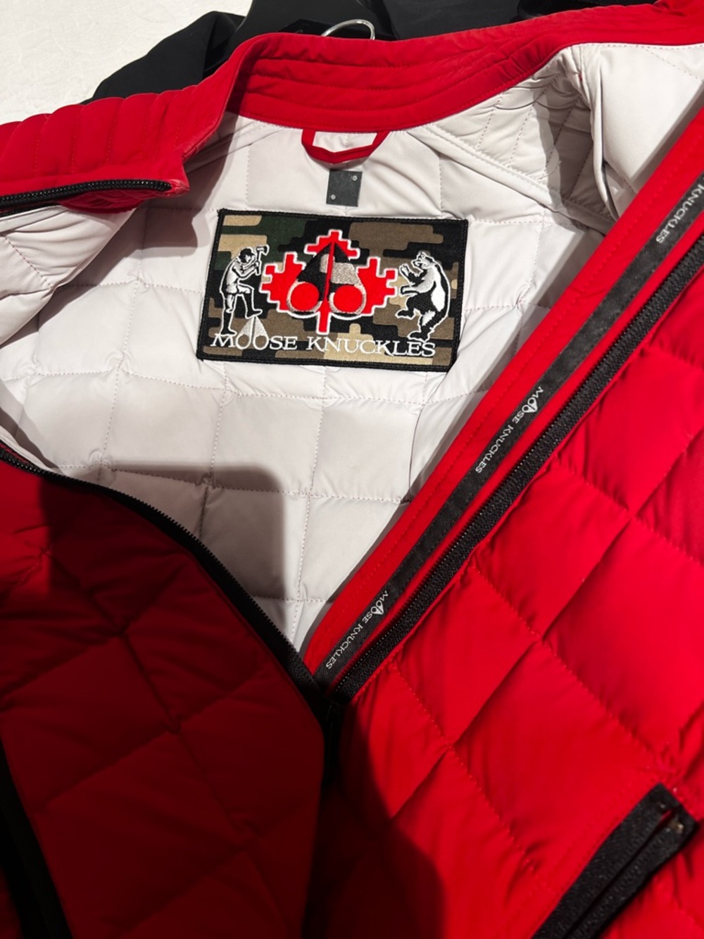 Moose Knuckles Red Quilted Jacket with White Interior and Black Trim